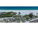 Aerial view of beachfront, palm trees, and coastal community at 1636 Stickney Point Rd # 36-201, Sarasota, FL 34231