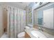 Charming bathroom featuring a shower/tub combo with a decorative shower curtain and tiled walls at 1636 Stickney Point Rd # 36-201, Sarasota, FL 34231