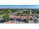 Aerial view of low rise condos with tile roofs and parking in view at 1636 Stickney Point Rd # 36-201, Sarasota, FL 34231