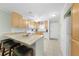 Bright kitchen featuring granite countertops, wooden cabinets, and a breakfast bar at 1636 Stickney Point Rd # 36-201, Sarasota, FL 34231