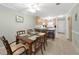 Combined living and dining area with tile flooring, ceiling fans and kitchen bar at 1636 Stickney Point Rd # 36-201, Sarasota, FL 34231