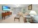 Well-lit living room with tile flooring, ceiling fan, and a large sectional sofa at 1636 Stickney Point Rd # 36-201, Sarasota, FL 34231