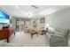 Comfortable living room with tile flooring, ceiling fan, and access to patio at 1636 Stickney Point Rd # 36-201, Sarasota, FL 34231