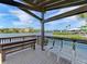 Chairs and Bench on a wooden deck overlooking the calm waters and waterfront condos at 1636 Stickney Point Rd # 36-201, Sarasota, FL 34231