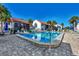 Community pool at Madeira Beach condos with lounge chairs and palm trees at 1636 Stickney Point Rd # 36-201, Sarasota, FL 34231