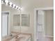 Bathroom featuring double sinks, a large mirror, and a tiled floor at 1697 San Silvestro Dr, Venice, FL 34285