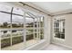 Enclosed room with large window, pond view, and screened patio at 1697 San Silvestro Dr, Venice, FL 34285