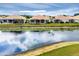 View of rear home exteriors featuring a pond, and screened lanais at 1697 San Silvestro Dr, Venice, FL 34285
