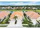 Charming home exterior featuring a tile roof, well-manicured lawn, palm trees, and a spacious driveway at 1697 San Silvestro Dr, Venice, FL 34285