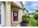 Inviting front entryway featuring a brick path and a vibrant red front door at 1697 San Silvestro Dr, Venice, FL 34285