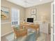 Bright office featuring a modern desk, coastal decor, and a cozy chair for remote work at 1697 San Silvestro Dr, Venice, FL 34285