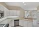 Bright kitchen featuring white cabinets and a view into another living space at 1697 San Silvestro Dr, Venice, FL 34285
