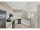 Bright kitchen with white cabinetry, stainless steel appliances, and a tiled floor at 1697 San Silvestro Dr, Venice, FL 34285