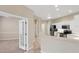 Open-concept kitchen with white cabinets and stainless steel appliances adjacent to dining area at 1697 San Silvestro Dr, Venice, FL 34285