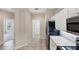 Galley kitchen with stainless steel appliances and tile flooring at 1697 San Silvestro Dr, Venice, FL 34285