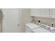 Convenient laundry room featuring a full-sized washer and dryer and upper cabinets at 1697 San Silvestro Dr, Venice, FL 34285