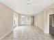 Spacious living room featuring tile floors, neutral paint, and arched doorways at 1697 San Silvestro Dr, Venice, FL 34285
