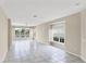 Expansive living room with tile floors, large windows, and ample space for entertaining at 1697 San Silvestro Dr, Venice, FL 34285