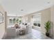 Open living room with neutral decor, tile floors, and picturesque windows offering serene views at 1697 San Silvestro Dr, Venice, FL 34285