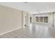 Spacious living room with tile flooring and large windows offering picturesque outdoor views at 1697 San Silvestro Dr, Venice, FL 34285