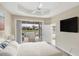 Inviting main bedroom with a screened-in patio view and a flat screen television at 1697 San Silvestro Dr, Venice, FL 34285
