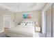 Comfortable main bedroom with tray ceiling, ensuite bathroom, and access to the lanai at 1697 San Silvestro Dr, Venice, FL 34285