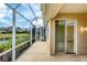 A screened patio with tile floor overlooks a scenic pond, offering a relaxing outdoor space at 1697 San Silvestro Dr, Venice, FL 34285