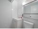 Compact bathroom with a white vanity, toilet, and mirrored cabinet at 1703 Bal Harbour Dr # 2, Venice, FL 34293