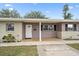 Inviting home entrance with a tiled porch and a neatly painted front door with sidelight at 1703 Bal Harbour Dr # 2, Venice, FL 34293
