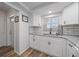 Updated kitchen showcasing granite countertops, white cabinets, and modern fixtures at 1703 Bal Harbour Dr # 2, Venice, FL 34293