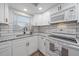 Updated kitchen featuring granite countertops, white cabinets, and stainless steel appliances at 1703 Bal Harbour Dr # 2, Venice, FL 34293