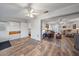 Spacious living room with wood-look flooring, a ceiling fan, and a view into the living area at 1703 Bal Harbour Dr # 2, Venice, FL 34293