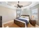 Bedroom with tray ceilings, a ceiling fan, neutral paint, and a window with horizontal blinds at 19227 Palmdale Ct, Port Charlotte, FL 33948