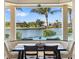 Dining area with serene waterfront views and comfortable seating at 19227 Palmdale Ct, Port Charlotte, FL 33948