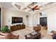 Cozy living room with tile flooring, a modern ceiling fan, and a comfortable seating area at 19227 Palmdale Ct, Port Charlotte, FL 33948