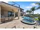 Covered outdoor kitchen with bar seating and waterfront views, equipped with high-end appliances for seamless al fresco dining at 19227 Palmdale Ct, Port Charlotte, FL 33948