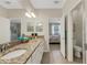 Bathroom features granite counters, dual sinks, and access to the bedroom and water closet at 19340 Bluff Dr, Venice, FL 34292