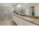 Bathroom with granite countertops, double sinks, and a glass shower at 19340 Bluff Dr, Venice, FL 34292