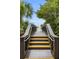 Wooden boardwalk with steps leading to the beach, offering a clear path to the sandy shores of Venice, Florida at 19340 Bluff Dr, Venice, FL 34292