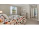 Bedroom features a floral comforter, white dresser, and a large window at 19340 Bluff Dr, Venice, FL 34292