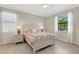 Inviting bedroom with colorful comforter, two windows, and tile flooring at 19340 Bluff Dr, Venice, FL 34292