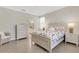 Comfortable bedroom with floral comforter, side tables, and access to bathroom at 19340 Bluff Dr, Venice, FL 34292