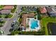 Aerial view of a resort-style pool with a unique shape, lounge chairs, and lush landscaping at 19340 Bluff Dr, Venice, FL 34292