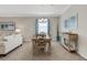 Bright dining area with a wooden table, coastal decor, and tile flooring for a modern style at 19340 Bluff Dr, Venice, FL 34292