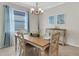 Bright dining room with wood table, modern lighting, and large window at 19340 Bluff Dr, Venice, FL 34292