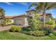 Charming home featuring lush landscaping, a tile roof, and a well-manicured lawn, creating inviting curb appeal at 19340 Bluff Dr, Venice, FL 34292