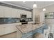 Modern kitchen boasts white cabinetry, granite countertops, stainless steel appliances and a breakfast bar at 19340 Bluff Dr, Venice, FL 34292