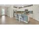 Open kitchen featuring a large granite island, stainless appliances, and seamless flow to dining and living areas at 19340 Bluff Dr, Venice, FL 34292