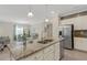 Well-lit kitchen with granite counters, stainless appliances, and open sight lines to the dining and living spaces at 19340 Bluff Dr, Venice, FL 34292