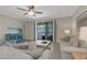 Comfortable living room features a ceiling fan, tile floors, and screened outdoor patio at 19340 Bluff Dr, Venice, FL 34292